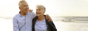 Older couple enjoying a walk on the beach