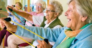 Group of older women exercising with resistance bands