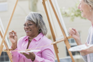 Multi-ethnic older women painting