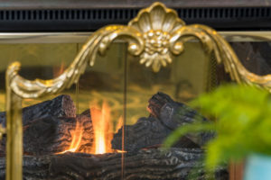 Decorative fire screen in front of a burning fire