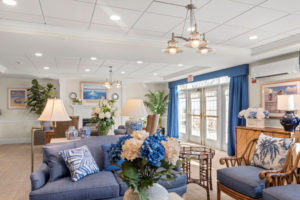 Living room seating area with blue and white floral arrangements