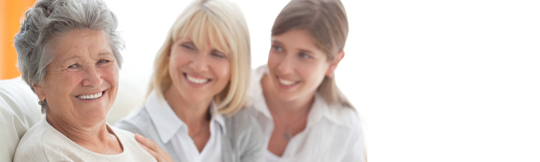 Older woman with her adult daughter and adult granddaughter