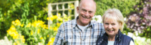 Older couple walking in the gardens