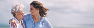 Older woman with her adult daughter on the beach