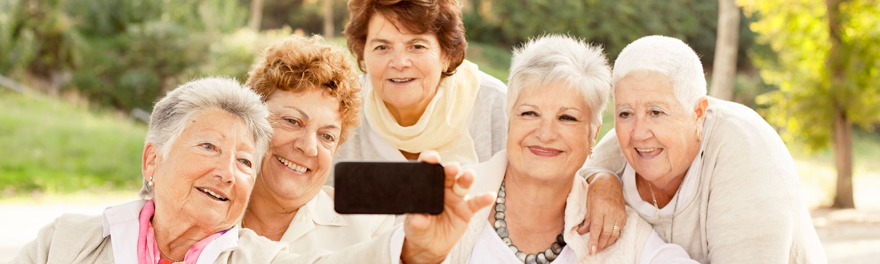 Five older friends taking a selfie