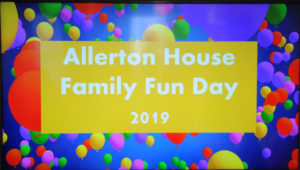 Brightly colored sign reading Allerton House Family Fun Day 2019