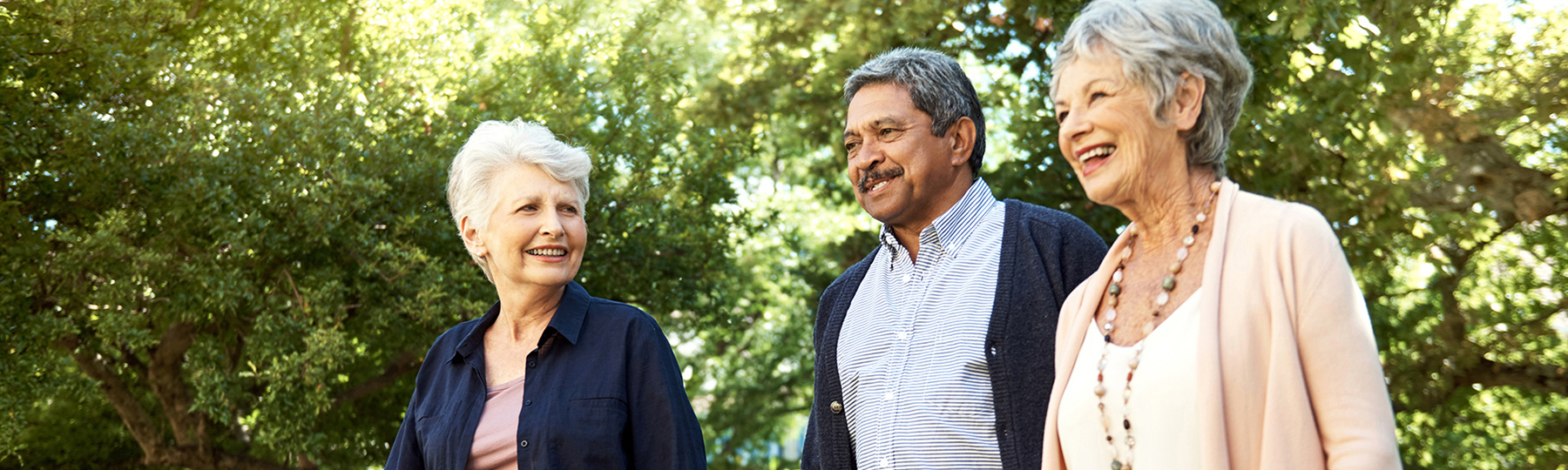 Three older people walking outdoors