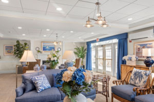 Comfortable living room with lots of blue and white floral arrangements