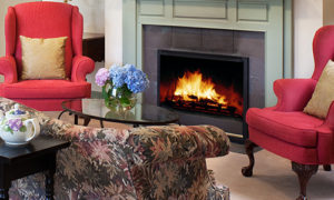 Living room sitting area with a fire in the fireplace