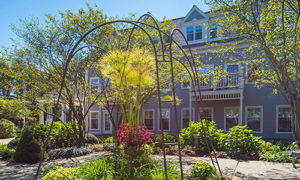 Blooming plants in a well-kept courtyard of a Welch Senior Living community