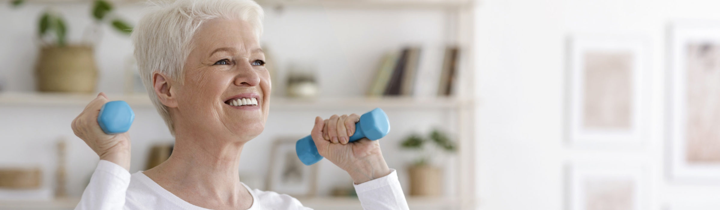 Senior woman exercising with small hand weights