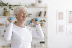 Senior woman exercising with small hand weights