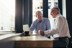 Two men conferring at a computer